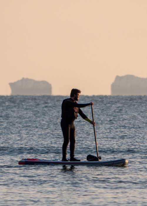 Paddleboarding on the solent with The Needles in the background in the New Forest